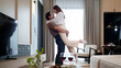 © Pichsakul - Romantic Asian Couple Embracing at Home with Red Wine Glasses Love and Intimacy in Modern Living Room Celebrating Anniversary Together
