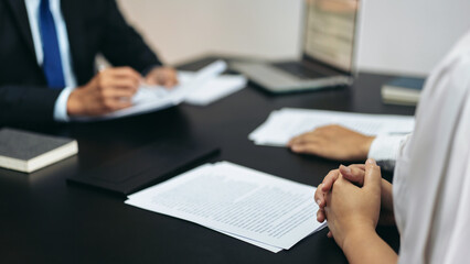 Aufkleber - A man and a woman are sitting at a table with papers in front of them