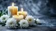 © Ronnayut - Serene background for condolence imagery showcasing lit candles and white chrysanthemums.