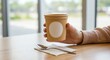 © Ascents - Mockup of a paper cup with blank label held in hand