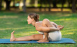 © JackF - Athletic young girl enjoying outdoor yoga practice on glade in green city park on serene summer day, engaged in graceful challenging asana enhancing physical capabilities and inner balance