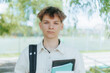 © Alexandr - Tired Student Standing by the Fence in the Schoolyard