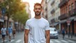 © Konstantin - Man standing in blank cotton white t-shirt mockup against city street background. Lifestyle clothing template