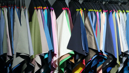 Poster - rack of clothes with a variety of colors and patterns. Concept of variety and abundance, with many different options to choose from