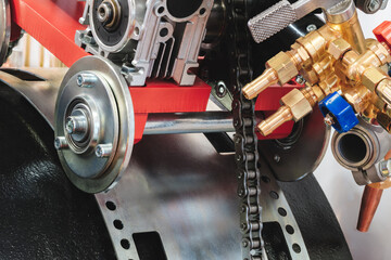 Aufkleber - A chain is attached to a red engine. The chain is made of metal and is attached to the engine