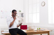© Prostock-studio - Pensive african-american businessman in office, reading news on tablet