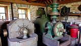 Restored mill stone casing and milling equipment in historic watermill
