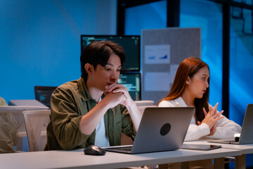 asian software engineer or programmer team working late in development office,problem solving or alg