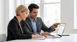 © Jessica - Two business professionals collaborating over a laptop in a bright office space
