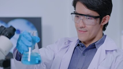 Wall Mural - asian researcher using a microscope in the clinical lab.male researcher working in the clinical labo