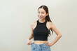 © Pormezz - Shape slender, thin waist, slim fit asian young woman, showing body shape her weight loss, happy wearing in big, large or oversize jeans, excess lose by diet and exercise. Healthy lifestyle concept