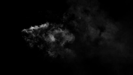 Wall Mural - isolated puff of white fog or smoke appears and drifts gently before dissipating on a black backgrou