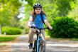 © Volodymyr - Child bike ride. Teen boy biking down summer road. Kid riding bicycle with smile. Child cycling. Kid ride on bike. Happy boy on bike. Child biking outdoors. Children biking. Little biker.