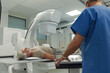 © Halfpoint - Doctor operationg CT machine in hospital.