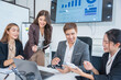 © panomporn - Group of professional business people or accountants working together on financial investment on calculator, doing calculation, analyzing business growth and marketing on graph in modern office.