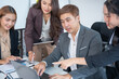 © panomporn - Group of professional business people or accountants working together on financial investment on calculator, doing calculation, analyzing business growth and marketing on graph in modern office.