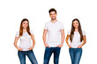 © deagreez - Portrait of charming people with long hair smiling putting hands in pockets wearing white t-shirt denim jeans isolated over yellow background