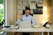 © saltdium - Smiling Businessman Waving on Video Call, Virtual Business Communication