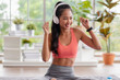 © weedezign - young healthy asian woman listening music while practice yoga at home
