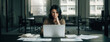© Shootdiem - Professional female working at her desk with a laptop and documents in a modern corporate office, deeply engaged in strategic analysis.