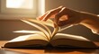 © Zakky - Hand turning book pages soft light