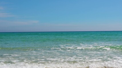 Wall Mural - Landscape of the morning beach with turquoise water and light suns at low tide