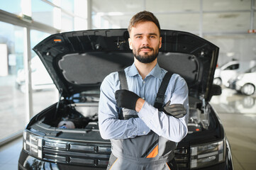 Fototapete - Troubleshooting process. Auto mechanic working in garage. Repair service