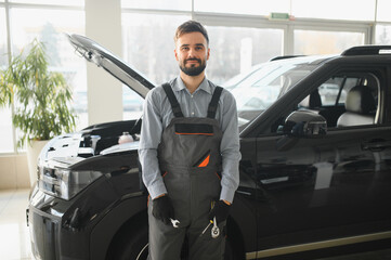 Fototapete - Troubleshooting process. Auto mechanic working in garage. Repair service