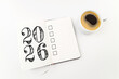 © missmimimina - New year resolutions 2026 on desk. 2026 goals list with notebook, coffee cup on white. Resolutions, plan, goals, action, checklist, idea concept. New Year 2026 resolutions, copy space