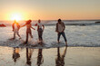 © bernardbodo - Friends running and having fun on the beach at sunset