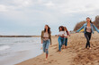 © bernardbodo - Female friends having a blast by the ocean