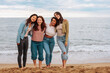 © bernardbodo - Happy friends hugging and posing by the beach
