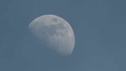 Wall Mural - Full moon over blue sky. Gibbous moon between clouds