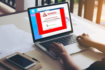 programmer using laptop with triangle warning signs, cryptography, cryptographic, hacker, virus for 