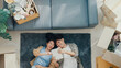 © tirachard - Top view. Happy Asian couple lay down on carpet use tablet shopping online furniture from decoration store in living room at new house. Husband wife move house, Apartment Rent And Ownership Concept.
