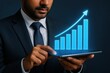 © Nattapol - Businessman suit using tablet with glowing digital graph showing