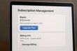 © Creative mind - Subscription management information displayed on a laptop screen, showcasing a basic plan and billing details. The user is provided with options to upgrade or manage the current billing information