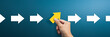 © Worawut - Group of arrows in one direction and businessman hand holding arrow pointing in the different way. Business concept for new ideas creativity and innovative solution