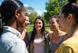 © starush - Group of diverse women smiling and talking outdoors on a sunny day