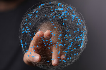 Fototapete - Abstract image of a hand interacting with a digital sphere representing global network connections.