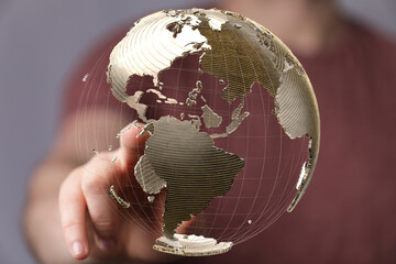 Fototapete - Abstract image of a hand interacting with a 3D model of the Earth, representing global connectivity and networking.