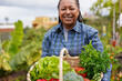 © Sabrina - Happy senior african woman holding fresh harvested vegetable at house garden - Organic food and healthy lifestyle concept