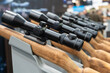 © ZenitX - Hunting rifle scopes on display at a show