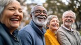 Joyful senior friends laughing together outdoors, multi-racial elderly group enjoying nature