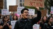 © Vyatcheslav - Young man shouting while holding protest sign during demonstration