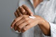 © Mirador - Close-up of a person applying moisturizing cream to the back of their hand with gentle care. Represents skincare, self-care, and beauty routines for health and wellness content.