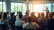 © NASSRI - Presenter Presenting on Stage at Conference Meeting. Professional Lecture. Blurred Unidentifiable Presenter and Audience. Corporate Executive Manager Speaker. People Attendees, Company seminar class