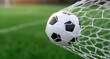 © sornram - A close-up of a soccer ball hitting the net during a match, showcasing excitement and energy in sports.