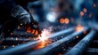 © somchai20162516 - Skilled Welder Creating Bright Sparks while Working on Steel Pipes in Industrial Setting with Dramatic Lighting