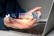 © jittawit.21 - Businessman planning financial budget 2026 with digital chart and icon on laptop screen for future strategy